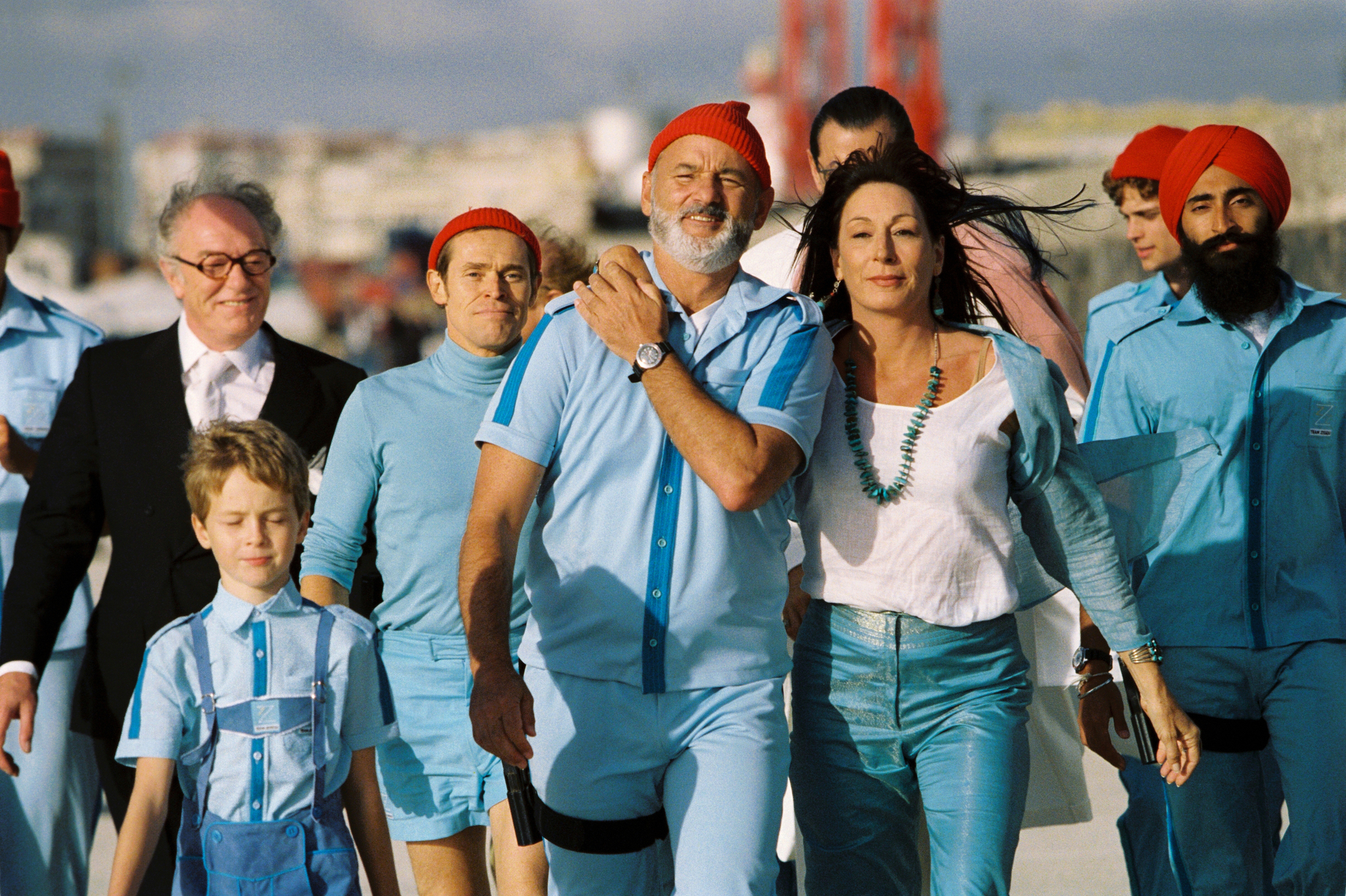 A happy Team Zissou walking towards the Belafonte 